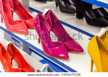 New elegant pink women shoes in the retail clothing shop display shelf