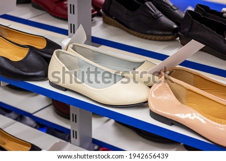 New elegant women shoes on the retail clothing shop display shelf