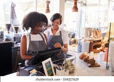 New Employee Receives Training At Delicatessen Checkout