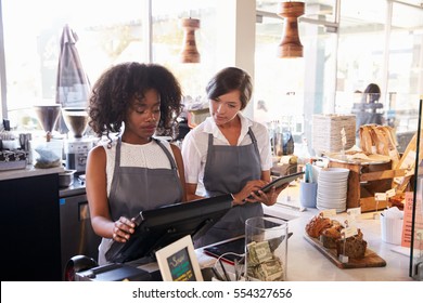 New Employee Receives Training At Delicatessen Checkout