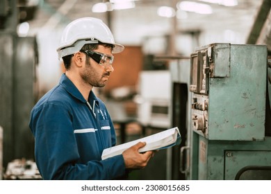 New Engineer Worker Reading User Manual Machine Instruction Guide Book to Working Operate Solving Problem in Metal Factory.