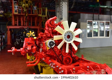 New Engines On Assembly Line Of Industrial Factory. Tractor Manufacture Work. Installation Of Parts On Agricultural Machinery Factory. 