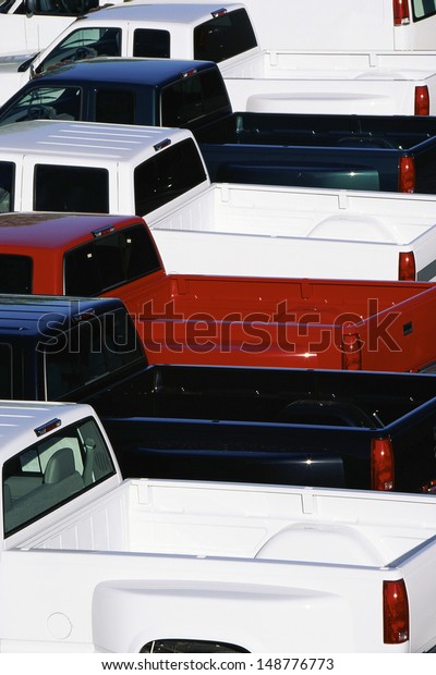 NEW\
ENGLAND - CIRCA 1990\'s: Pickup trucks parked in\
lot