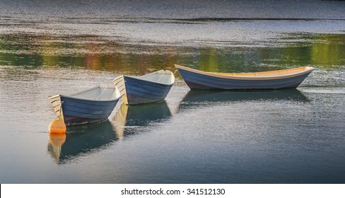 New England wooden Dory rowboats floating serenely in Kenneybunkport, Maine, USA