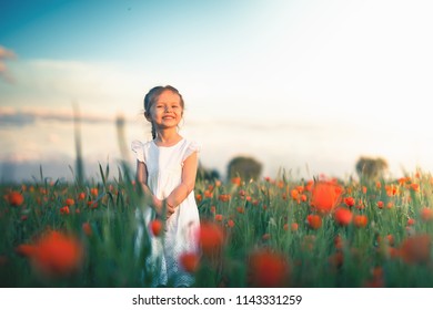 New Era Concept With Happy Kids And People. Happy Society. Successful Community. Little Girl Outdoor At Poppy Field. Autumn, Summer Season. Happy Family Values. Childrens Health Care