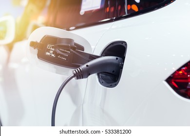 New era of vehicle fuel. Power charging of white modern electric car