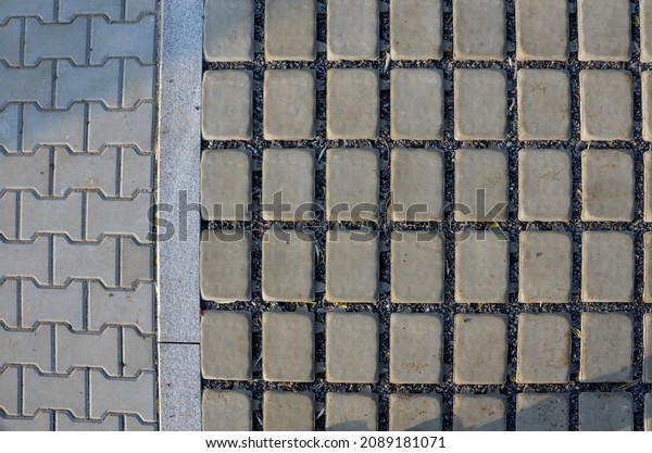 new established street in the city, the\
longitudinal parking lot is made of gray concrete infiltrating\
tiles with crevices filled with gravel. measures to limit the\
outflow of water from road\
bumps