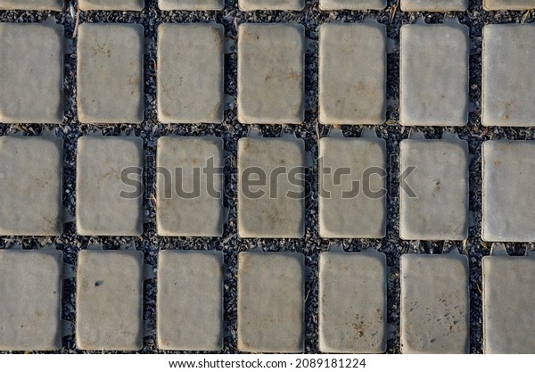 new established street in the city, the
longitudinal parking lot is made of gray concrete infiltrating
tiles with crevices filled with gravel. measures to limit the
outflow of water from road
bumps