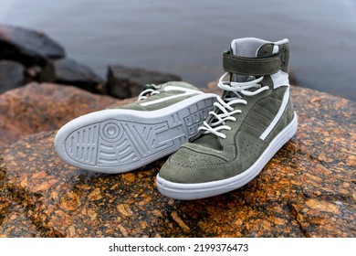 New Fashionable High Youth Sneakers On A Stone Background