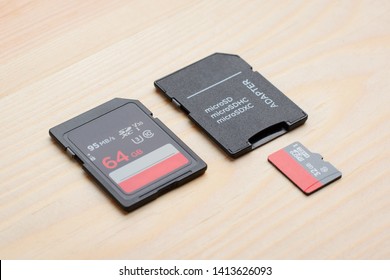 New fast memory cards on table. SD and micro sd card with adapter on wooden table