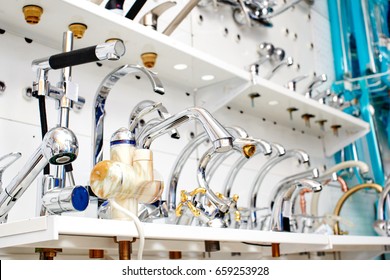 New Faucets On The Shelf In A Hardware Store Closeup