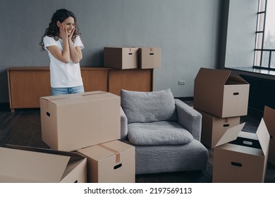 New First Home, Relocation. Happy Hispanic Female Homeowner Contemplating Empty Room, Standing Among Cardboard Boxes On Moving Day. Cute Smiling Woman Renter Feels Happiness With Removal.