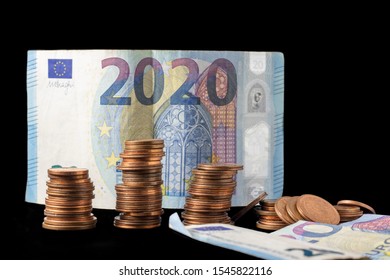 New Fiscal Year 2020 Represented With Euro Bills And Coin Stacks Isolated On Black. Conceptual Image Of The Economical Situation And Possible Upcoming Crisis.