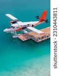 New floating dock at Male airport. Trans Maldivian Airways Twin Otter seaplanes. Exotic scene, seaplanes in calm ocean lagoon. Luxury travel vacation view. Transportation tourism background concept