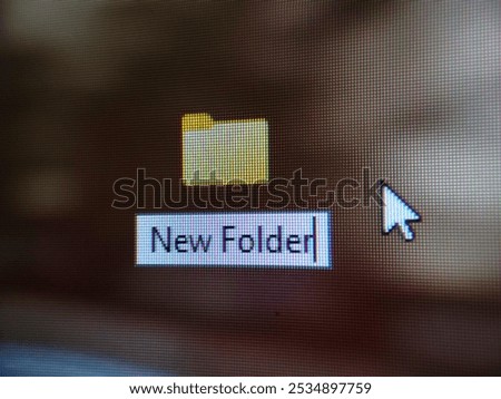 new folder icon with cursor on computer screen, close up