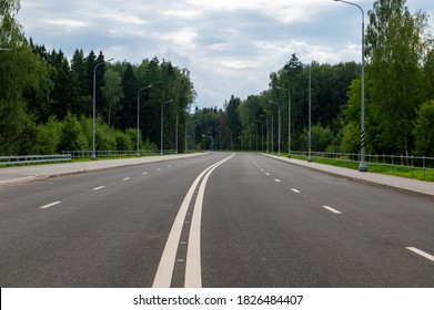 New four-lane highway with a forest background.
