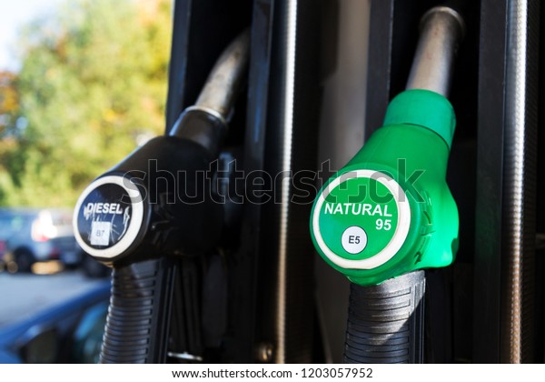 New fuel labeling at petrol station pumps with new EU\
labels, sunny day