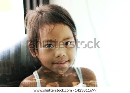 Similar – Funny child looking at the camera and painting