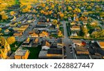 New Glarus Wisconsin at sunset showing city buildings, rooftops, and the Swiss United Church of Christ in golden light.