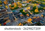 New Glarus Wisconsin at sunset showing city buildings, rooftops, and the Swiss United Church of Christ in golden light.