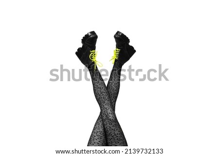 New gray female boots with bright yellow laces on long slender crossed woman legs in gray tights isolated on white background. Pop art concept with Heavy Duty Boots. Square Banner