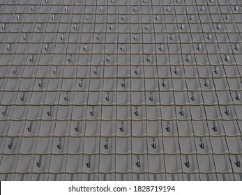 New gray roof tiles with snow guards