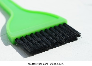 New Green Hair Dye Brush On White Table.