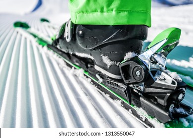 New Groomed Piste Or Slope. Lines In Snow. Winter Skis And Detailed View Of The Ski Bindings Concept.