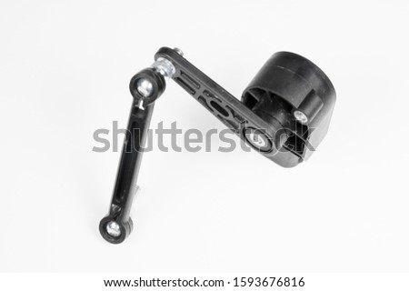New ground clearance sensor with plastic traction on a gray background. Accessories for cars with automatic suspension height adjustment