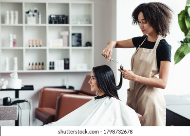 New hairstyle, new life. Young woman enjoying haircut at beauty salon, empty space
