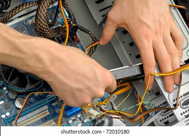 A new hard drive is being inserted into the computer case - Powered by Shutterstock