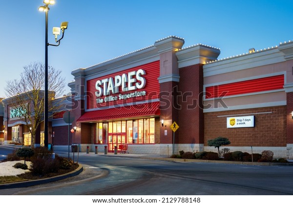 New Hartford, New York - Feb 24, 2022: Closeup\
Night View of Staples The Office Superstore Building Exterior.\
Staples Inc. is a US Office Retailer, It is Mainly Involved in the\
Sale of Office Supplies