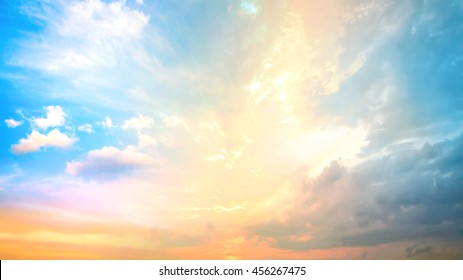 A new heaven and earth concept: Dramatic sun ray with blue orange color sky and clouds dawn texture background