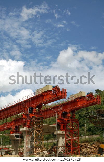 New highway construction site  work with Heavy\
orange equipments on blue\
sky