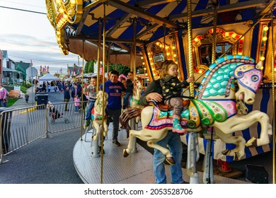 New Holland, PA, USA - September 30, 2021: Children And Adults Ride A Merry Go Round Carousel At The Annual Community Street Fair In The Small Community In Lancaster County, PA.