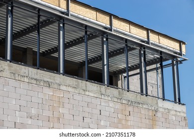 New Home Construction Of A Cement Block Home With Wooden Roof Trusses View From Outside Looking In.