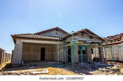 New Home Construction With Scaffolding During Stucco Phase