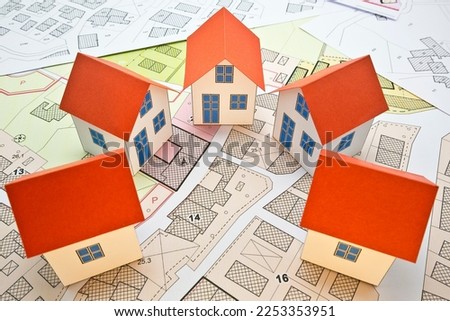 New home and free vacant land for building activity - Construction industry and building permit concept with a residential area, cadastral map, General Urban Planning and zoning regulations  
