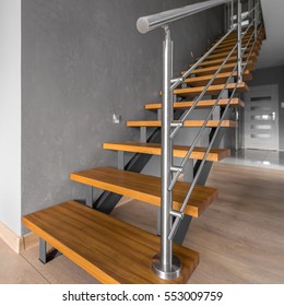 New Home Interior In Grey With Simple Wooden Staircase With Steel Railing