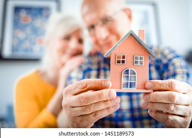 New House Concept, Happy Senior Couple Holding Small Home Model