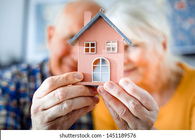 New House Concept, Happy Senior Couple Holding Small Home Model