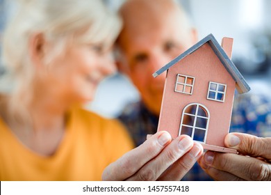 New House Concept, Happy Senior Couple Holding Small Home Model