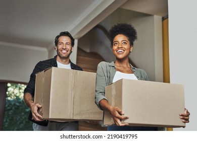 New house, moving and happy couple carrying boxes while feeling proud and excited about buying a house with a mortgage loan. Interracial husband and wife first time buyers unpacking in dream home - Powered by Shutterstock