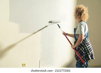 New House Renovation - Crafty Woman Roller Painting The Wall. High Quality Photo