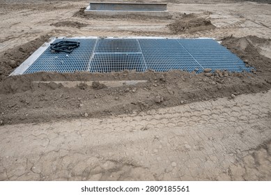 New housing development project, large underground stormwater catch basin vault with steel grate for access, stormwater management in a municipal infrastructure project
