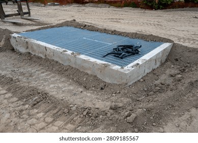 New housing development project, large underground stormwater catch basin vault with steel grate for access, stormwater management in a municipal infrastructure project
