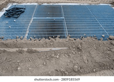 New housing development project, large underground stormwater catch basin vault with steel grate for access, stormwater management in a municipal infrastructure project
