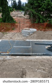 New housing development project, large underground stormwater catch basin vault with steel grate for access, stormwater management in a municipal infrastructure project
