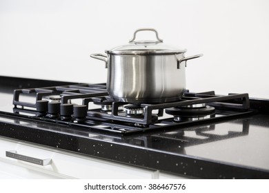 New Iron Pot On A Black Gas Stove On A Kitchen