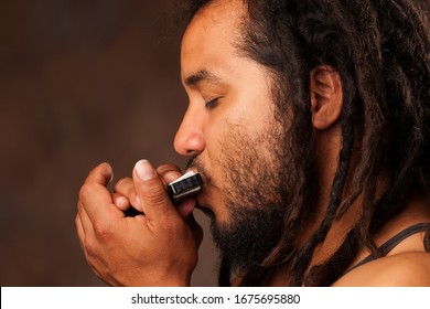 New Jazz Reed Orleans Rastafarian Instrument Rastafarian Man Playing Mouth Harmonica New Jazz Reed Orleans Rastafarian Instrument Color Play Colour Brown Emotion White Harmonica Nails Hand Face People